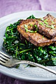 Tempeh, fried in garlic, with sesame seed spinach