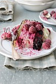 A slice of raspberry and blackberry cake