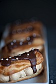 Chocolate covered eclairs with silver pearls and coffee cream