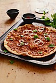 Lahmacun (yeast dough pizza base topped with minced lamb, pepper purée and spices, Turkey)