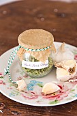 Homemade herb salad with basil and garlic in a preserving jar