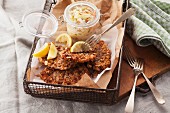 Pork escalope with a nut coating served with coleslaw