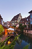 Petite Venise (Little Venice), Colmar, Alsace; a view from the Rue Turenne canal bridge onto La Lauch with restaurants lining the canal side
