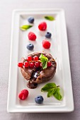 Chocolate tartlet with a liquid core and summer berries