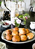 Dish of teacakes on black table