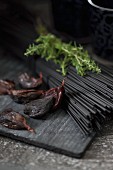 Black spaghetti coloured with coal (edible coal from Japan, for vegetarians), rosemary and black garlic
