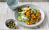 Cucumber carpaccio with chilli prawns and green olives