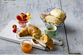 Breakfast with croissant, jam, espresso, rolls and fruit