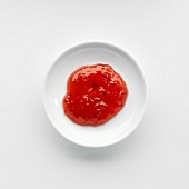 A portion of raspberry jam on a plate