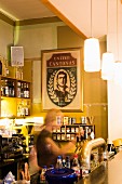 A waitress behind the bar in 'Café Cantona', Leipzig