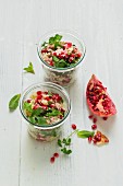 Couscous salad with pomegranate seeds, parsley and mint
