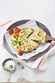 Courgette omelette with feta cheese, leek, parsley and mint
