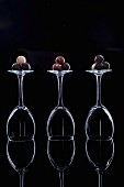 Chocolate truffles on overturned wine glasses