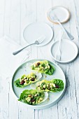 Cos lettuce leaves filled with avocado and cashew nut salad