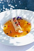 Cannelloni filled with crab in a sauce with edible flowers