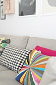 Colourful and patterned scatter cushions on ecru sofa