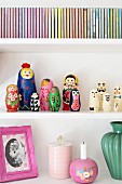 Detail of shelves holding Russian dolls, vintage collectors' items and CD cases