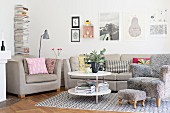 Ecru sofa set and comfortable armchair with grey fluffy cover and matching footstool on rug in living room