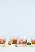 Pink summer drinks with limes and ice cubes