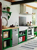 Rustic kitchen with functional counter and green-painted base units