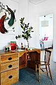 Vintage desk, wooden chair, wooden toys, white-framed picture of birds and view into child's bedroom