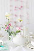 Tea crockery and flowers on a romantic buffet