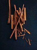 Cinnamon sticks on a dark surface