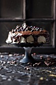 Dark chocolate cake with icing, chocolate glaze and cocoa nibs