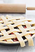 An unbaked berry pie with a lattice lid