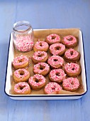 Mini doughnuts with pink glaze and sprinkles