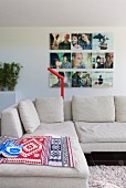 Comfortable reading area with ethnic rugs on designer sofa and photo art on wall