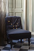 Antique chair upholstered using uniform jacket