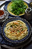 Hummus with whole chickpeas, spices and herbs