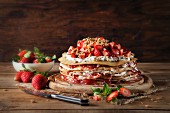 A crepes cake filled with cream cheese, strawberries and strawberry jam