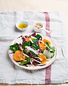 Spinach salad with mandarins and pine nuts