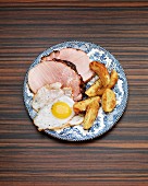 Roast ham with an fried egg and potato wedges