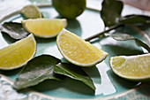 Lime wedges and keffir lime leaves on a plate