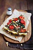 Spinach quiche with tomatoes and pine nuts