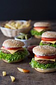 Homemade burgers with a basket of chips, tomato sauce and gherkins