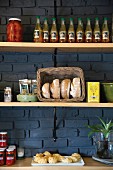 Bread, preserves and savoury pastries on pantry shelves