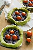 Raw pesto tartlets with onion confit and cherry tomatoes