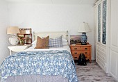 Rustic blue and white bedroom with eclectic mixture of furniture