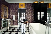 Ornamental wallpaper and chequered floor in glamorous bathroom