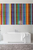 Mosaic of colourful wide stripes above white designer bathtub