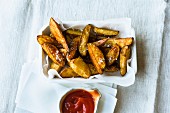 Homemade potato wedges with ketchup
