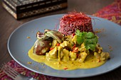 Lamb and coconut curry with aubergines, red rice and chilli threads (India)