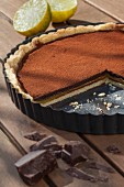 Shortcrust pastry with lemon curd and dark chocolate in a baking tin