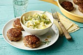 Mini meatballs made from tatar with a cucumber and dill salad