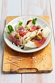 Melon with ham, olive oil and balsamic sauce