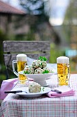 Breadcrumb dumplings and beer in a restaurant garden